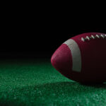MOCKUPs__0004_29575002_close-up-of-american-football-on-artificial-turf_AOAY2652