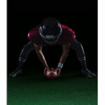M7_0016_ML_0021_29574278_american-football-player-bending-holding-a-ball-on-turf_AOAY2640